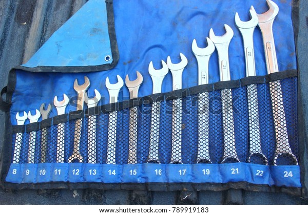Wrenches on blue\
garage wall set of\
wrenches.