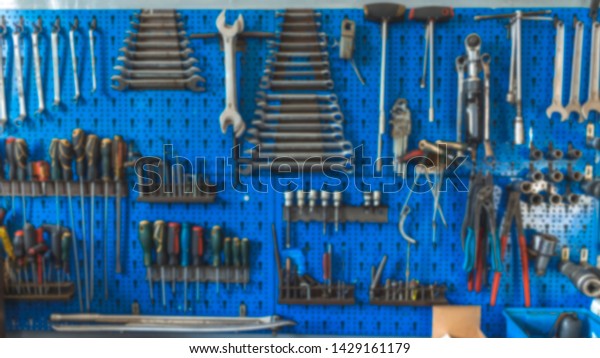 Wrenches set in the\
workshop. Some wrenchs and tools on the tool shelf. Work tools on\
the garage wall and work table. Workshop tool holder with a wrench\
and set of wrench\
sockets