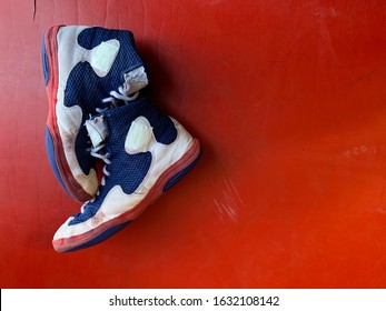 Wrestling Shoes On A Red Mat With An Overhead View.