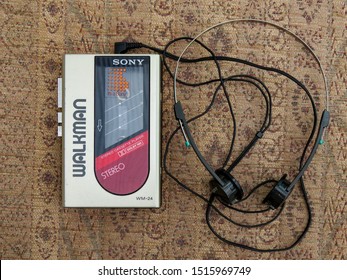 Wrexham, UK - April 12, 2019: Sony Walkman portable personal audio cassette player. Model WM-24 with headphones. Genuine retro personal music system from the 1980s.