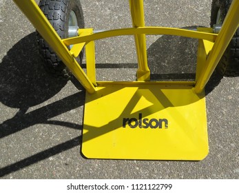 WREXHAM, UK - AUGUST 27, 2015: Heavy Duty Empty Yellow Rolston Sack Barrow With Shadows Viewed From Above. Close Up.