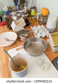 Wrexham, UK - June 26, 2018: Authentic Messy Domestic Kitchen Worktop With Dirty Dishes, Broken Eggshells, Google Home And Other Kitchen Paraphernalia.