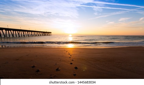 Wrightsville Beach near Wilmington North Carolina at sunrise. Taken on a cold day in winter, but the scene looks incredibly warm and inviting.