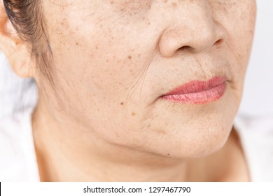 wrinkle freckles and skin line on close up elderly asian woman face 60-70 years old, healthy skin care concept