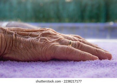 wrinkle hand with a ring. Elderly body part - Shutterstock ID 2238217177