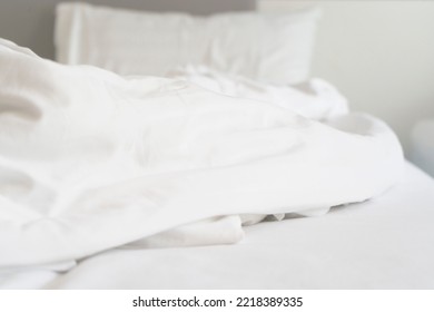 Wrinkle Messy Blanket And White Pillow In Bedroom After Waking Up In The Morning, From Sleeping In A Long Night, Details Of Duvet And Blanket, An Unmade Bed In Hotel Bedroom With White Blanket.