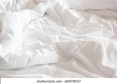 Wrinkle Messy Blanket And White Pillow In Bedroom After Waking Up In The Morning, From Sleeping In A Long Night, Details Of Duvet And Blanket, An Unmade Bed In Hotel Bedroom With White Blanket.