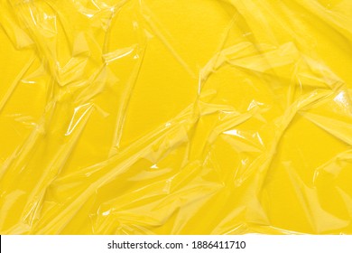 Wrinkled Cling Film Or Vinyl Background. Yellow Overlay. Art Design, Minimal Abstract Texture.