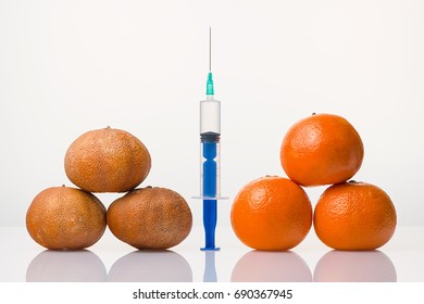 Wrinkled dried and smooth elastic tangerines the syringe