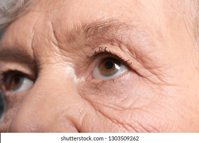 Wrinkled face of elderly woman, closeup of eyes