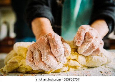 wrinkled hands making pasta for bread in traditional way - Powered by Shutterstock