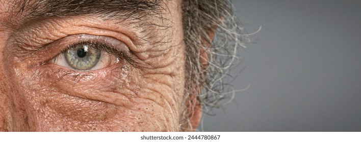 wrinkled old man  with blue eyes detail macro shot - Powered by Shutterstock