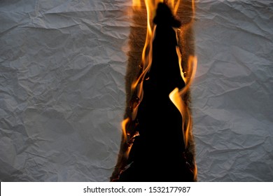 Wrinkled Paper That Was Burning On Fire On A Black Background