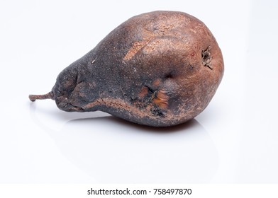 Wrinkled and rotten brown pear isolated on white background. - Shutterstock ID 758497870