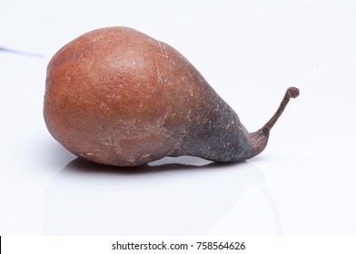 Wrinkled and rotten brown pear isolated on white background. - Shutterstock ID 758564626