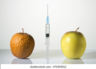 Wrinkled and smooth apples and the syringe