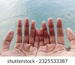 Wrinkly hands and fingers after swimming and submerged in water for too long