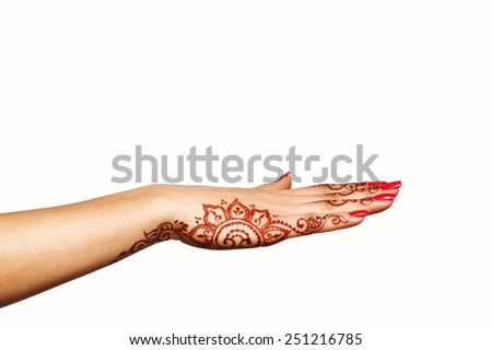 wrist and hand of young girl with henna mehendi on white background