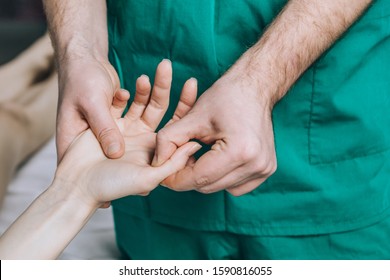 Wrist Massage. A Male Massage Therapist Puts Pressure On A Sensitive Point On A Woman's Hand.	