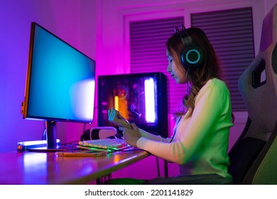 Wrist Pain Concept. Gamer And E-Sport Online Of Asian Woman Playing Online Computer Video Game With Lighting Effect, Broadcast Streaming Live At Home. Her Use Her Wrist For A Long Time.