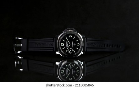 wrist watch brand Panerai or Pam model 005 black face is displayed on the black glass table shelf with black background in authorized dealer  Panerai shop in luxury duty free area