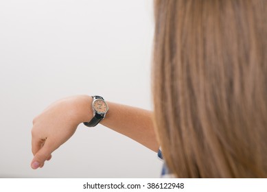 Wristwatch on the hand of teenager, time does not matter, girl with the clock - Shutterstock ID 386122948