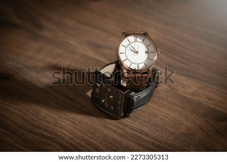 Wristwatch on the wooden background.