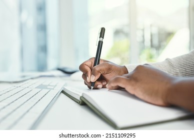 Write down your daily goals before you start each day. Cropped shot of an unrecognizable businesswoman writing in her notebook while sitting at her desk.