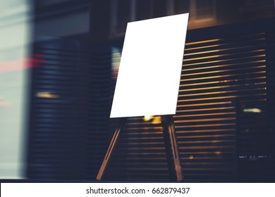 Write stylish chalkboard with mock up copy space are for your text message or advertising promotional content, empty presentation wooden board standing on the glass storefront