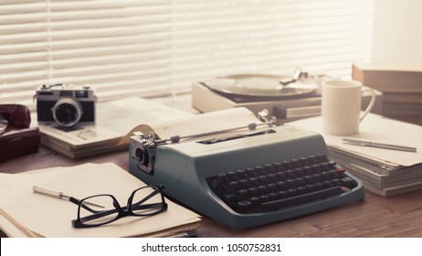 Writer, journalist and photoreporter vintage desktop with typewriter, camera and record player