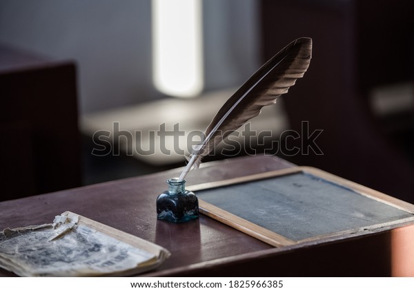 Writer vintage\
accessory: \
retro inkwell, fountain pen and ink, feather quill\
pen, paperweight, bell,\
candlestick