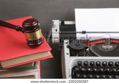 Writers desk - typewriter, books and judge's gavel, copyright protection law concept, copyrights day and international legal rights concept