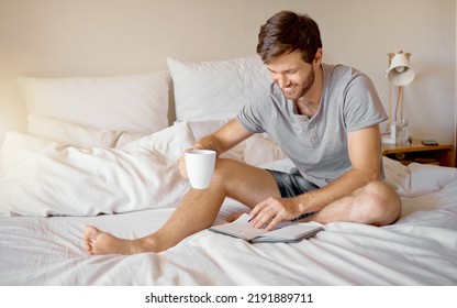 Writing, Bed Reading And Happy Man With Coffee With His Gratitude Dairy Or Motivation Journal. Guy With A Smile Relax At His House Bedroom In Peace With A Positive Mindset To Start The Day At Home