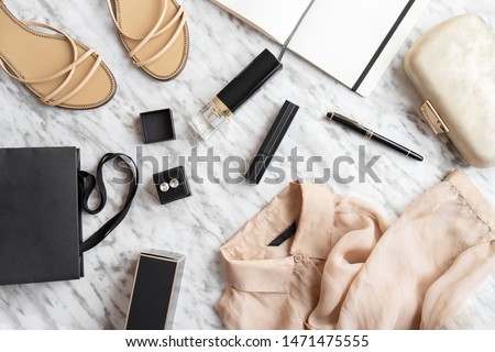 Writing a blog concept. Notebook and pen, woman accessories, clothing, shoes, bag, makeup and perfume white grey background. Fashion and Beauty flat lay.