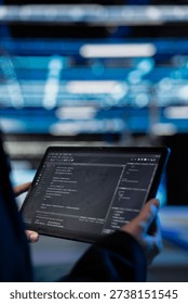 Writing code, tablet closeup and computer scientist in data center updating infrastructure network systems. Coding upgrades and worker typing on touchscreen device in server hub