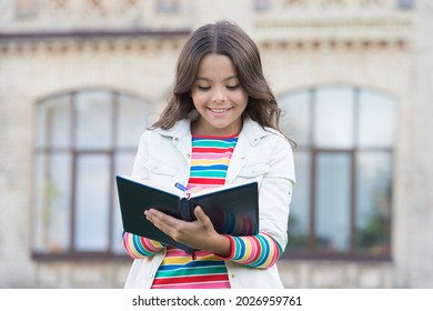 Writing A Diary. School Pupil Do Writing Task Outdoors. Happy Child Write In Copybook. Making Notes. Writing Lesson. Learning Foreign Language. English Grammar. Improving Hand Writing