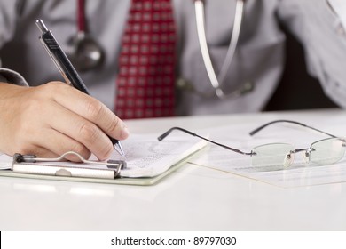 Writing Doctor, A Doctor In Red Tie Write Down On The Note Board.