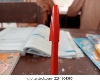 a writing instrument in the form of a nib with a sharp tip equipped with a handle filled with a refillable ink sac
