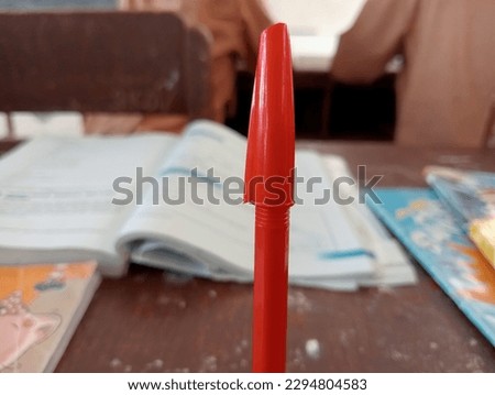 a writing instrument in the form of a nib with a sharp tip equipped with a handle filled with a refillable ink sac