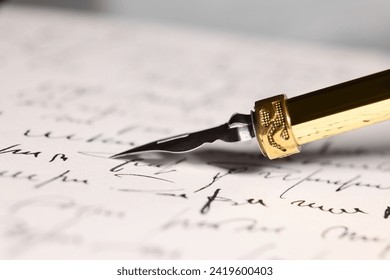 Writing letter with elegant fountain pen, closeup