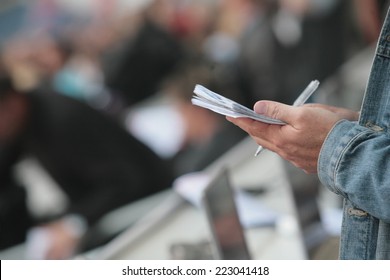 Writing Notebook Reporter In A Stadium