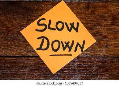 Writing on colorful sticky note slow down. Text with slow down on paper. - Shutterstock ID 1585404037