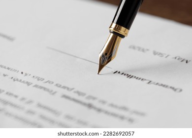 Writing on document with fountain pen at wooden table, closeup. Notary contract - Shutterstock ID 2282692057