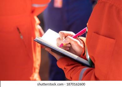 Writing Or Take Note Action Of Supervisor During Perform Safety Audit At Working Site Location. Close-up And Selective Focus At Person Hand.