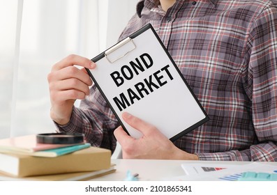 Writing Text Showing BOND MARKET. Writing Text BOND MARKET On White Notepad Paper, Green And Black Letters, Yellow Background. Business Concept.