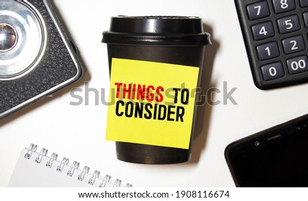 Writing text showing Things To Consider. Business concept for Business Knowledge written on notebook book on wooden background in the Office with laptop
