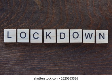 written "LOCKDOWN" with light wood letters on dark wood