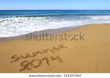 ?Summer 2014? written on sandy beach