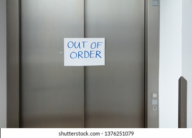 Written Text Out Of Order Message In White Paper On Closed Elevator Door