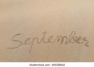 written words "September" on sand of beach - Shutterstock ID 445338562